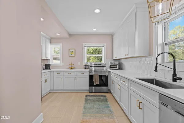 a kitchen with sink cabinets and window