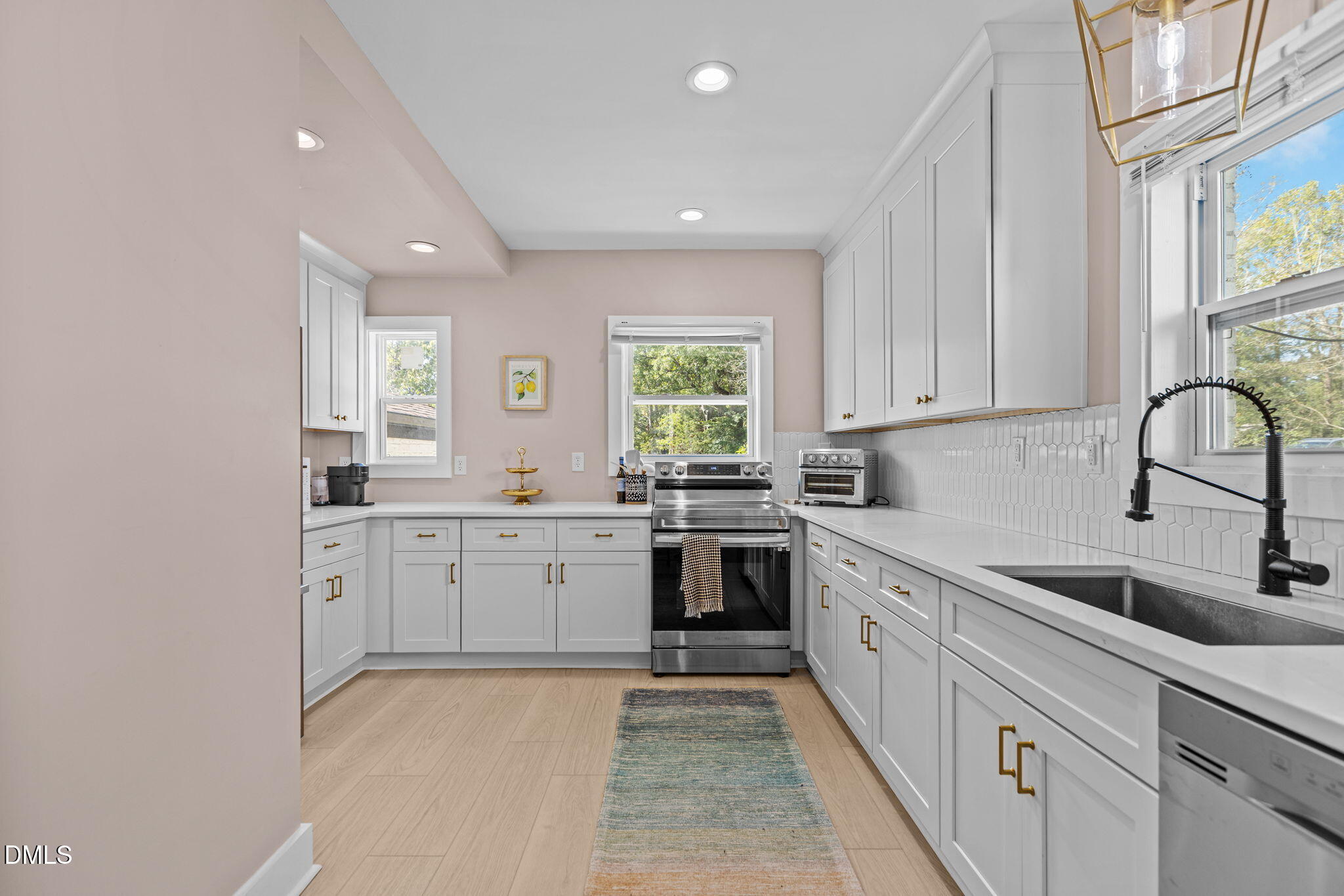 2707 North Roxboro Street Durham, NC 27704 - Photo 1 of 44 a kitchen with sink cabinets and window