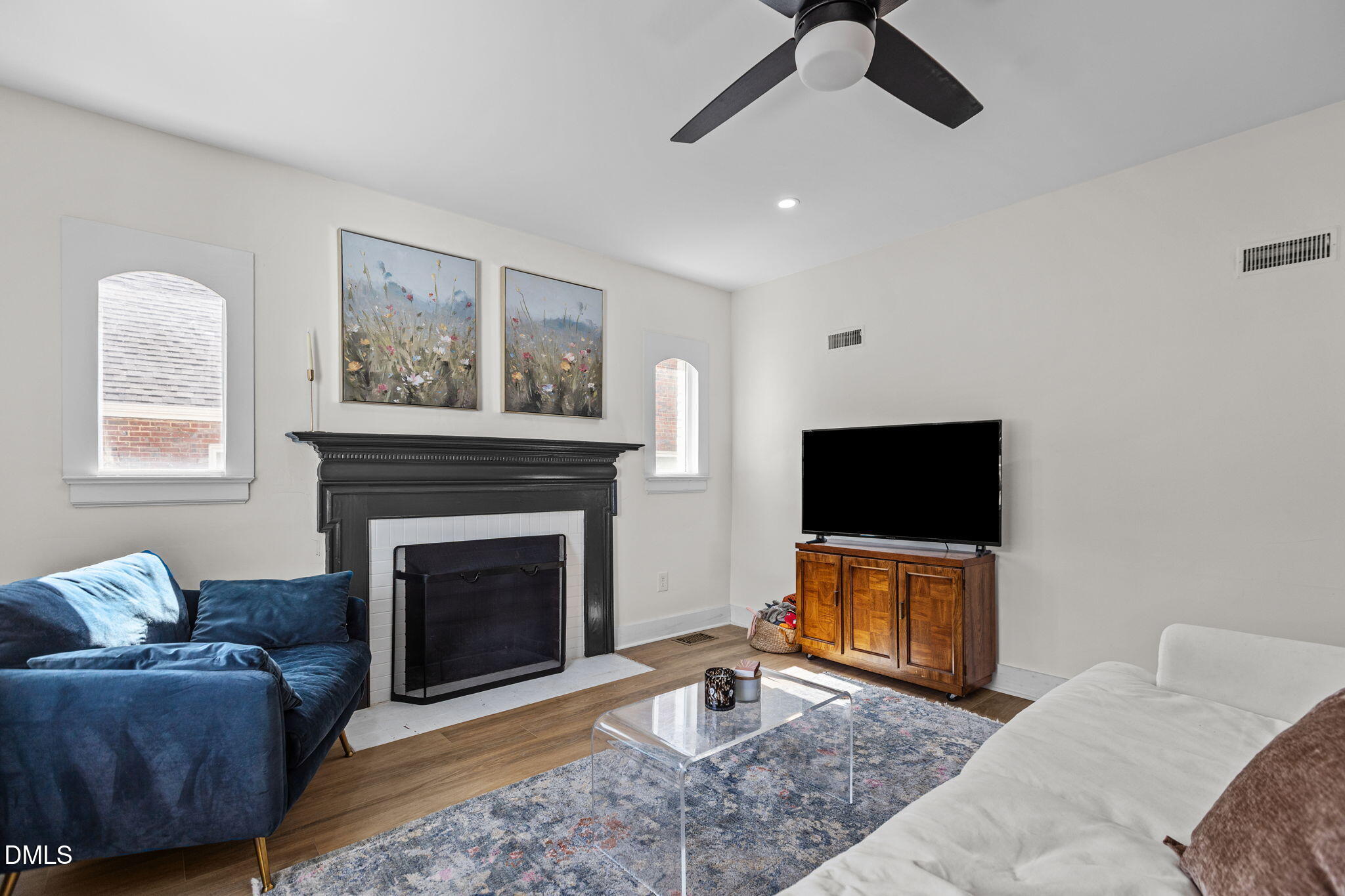 2707 North Roxboro Street Durham, NC 27704 - Photo 11 of 44 a living room with furniture a flat screen tv and a fireplace