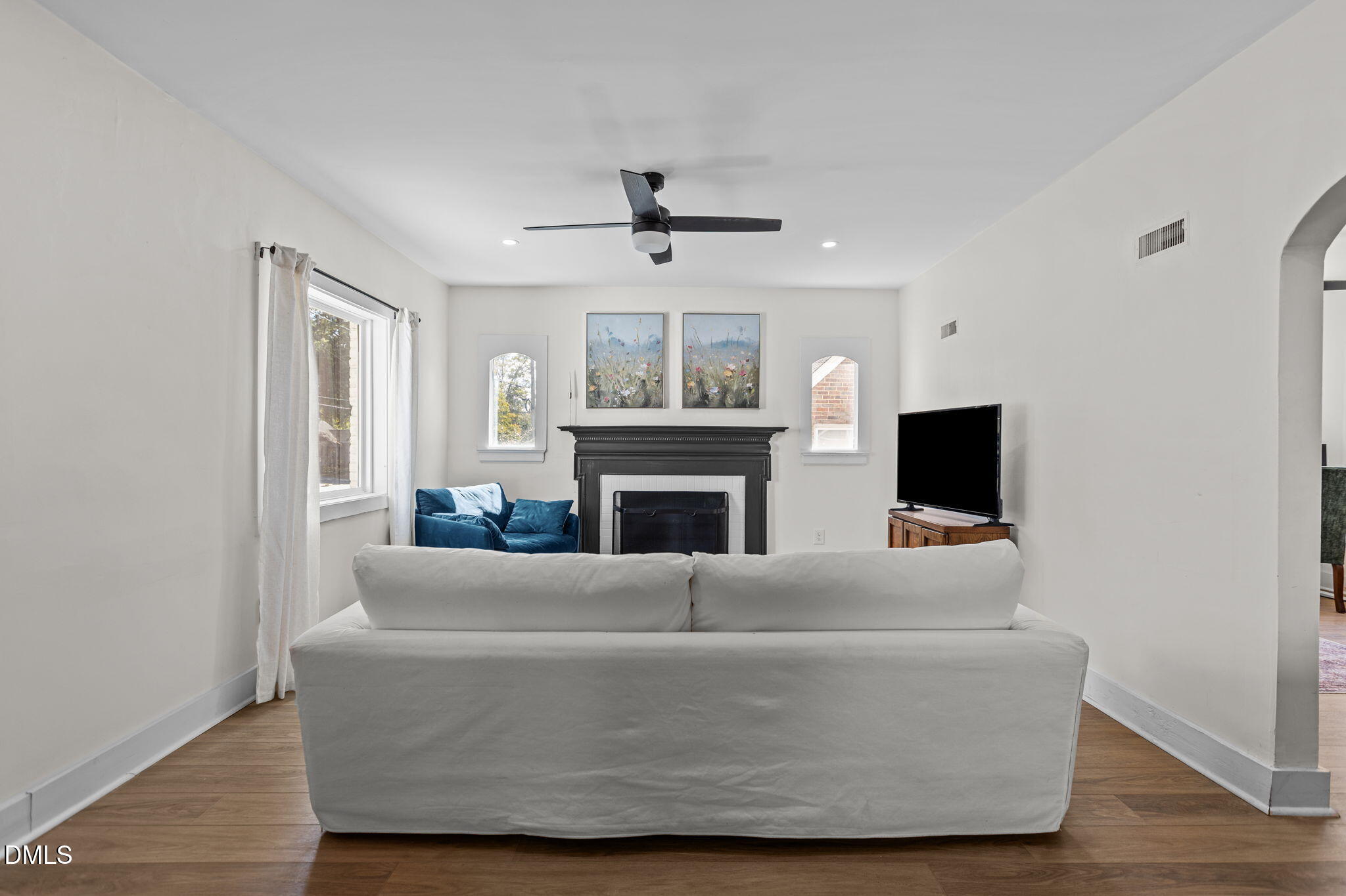 2707 North Roxboro Street Durham, NC 27704 - Photo 14 of 44 a living room with furniture a fireplace and a flat screen tv