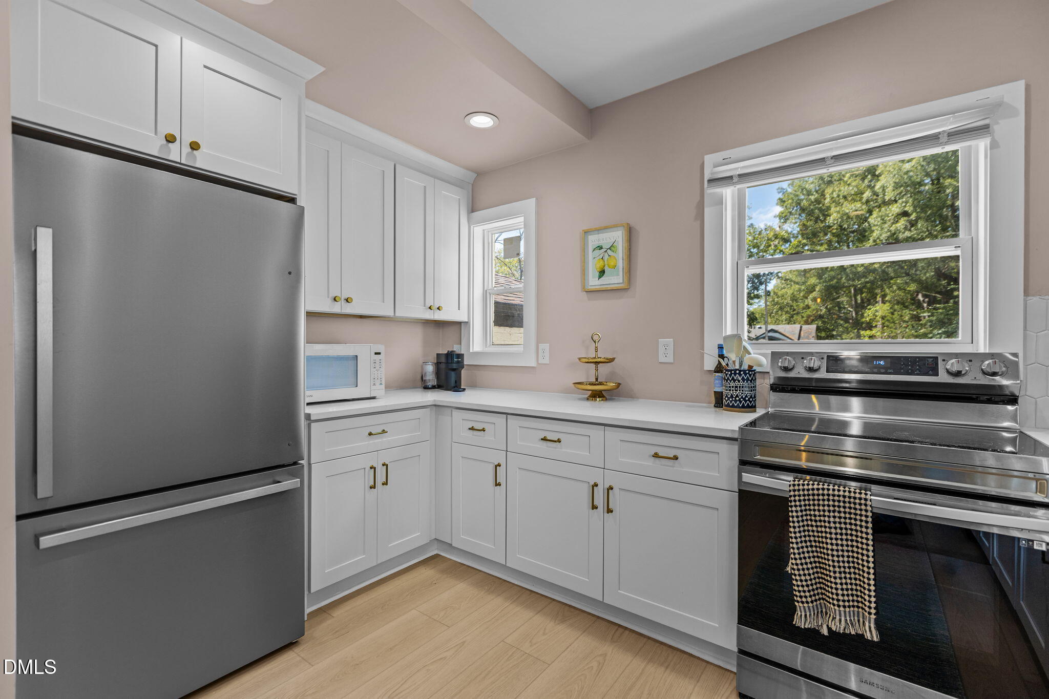 2707 North Roxboro Street Durham, NC 27704 - Photo 19 of 44 a kitchen with white cabinets and white appliances