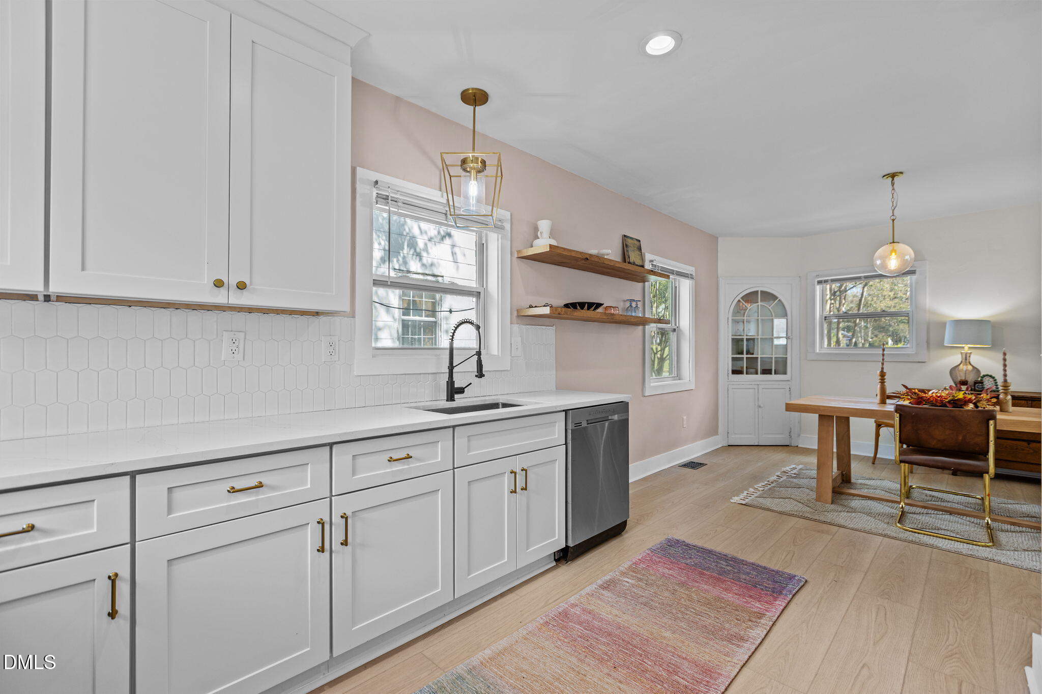 2707 North Roxboro Street Durham, NC 27704 - Photo 20 of 44 a kitchen with white cabinets and sink