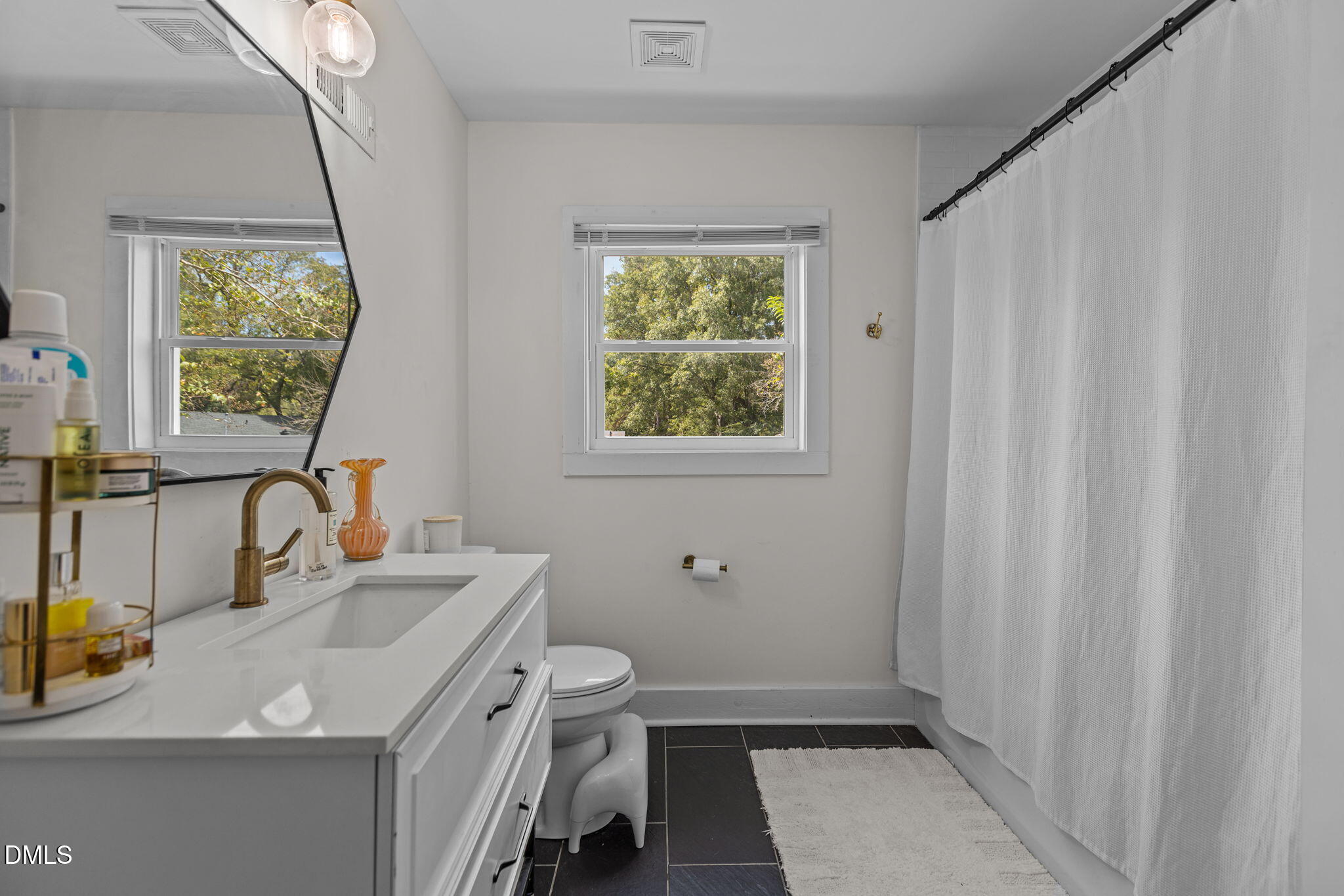 2707 North Roxboro Street Durham, NC 27704 - Photo 27 of 44 a bathroom with a sink a toilet and a window