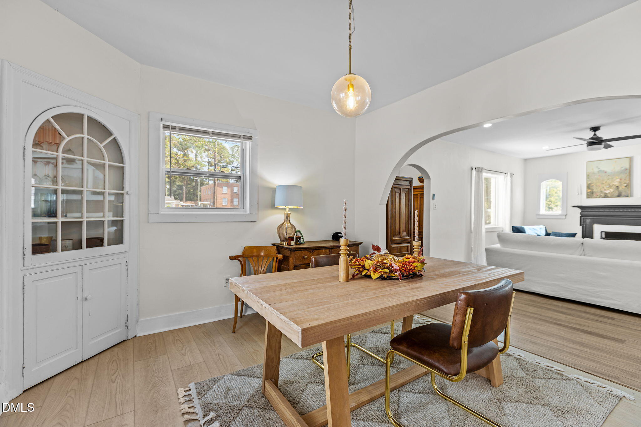 2707 North Roxboro Street Durham, NC 27704 - Photo 6 of 44 a view of a dining room and livingroom with furniture wooden floor a rug a potted plant and a chandelier