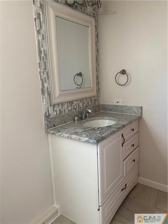 7 Poe Road North Brunswick, NJ 08902 - Photo 17 of 19 a bathroom with a granite countertop sink and a mirror