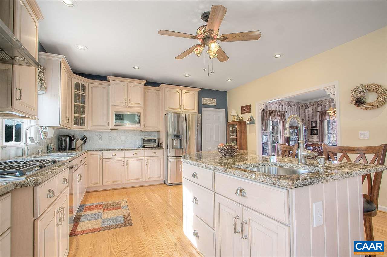 9075 Critzer Shop Road Afton, VA 22920 - Photo 12 of 32 a large kitchen with kitchen island a large counter space a sink appliances and cabinets