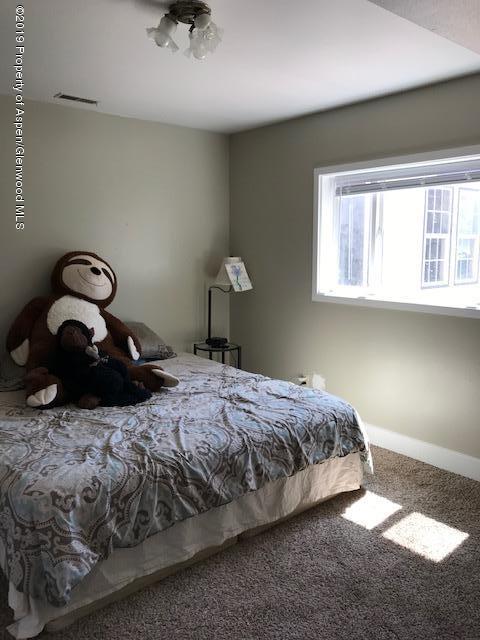 520 Elm Court Rifle, CO 81650 - Photo 13 of 37 a bedroom with a bed and window
