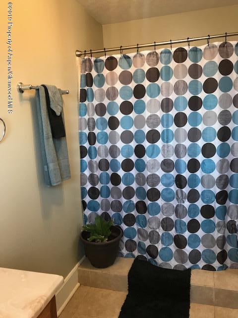 520 Elm Court Rifle, CO 81650 - Photo 19 of 37 a view of a bathroom with a black and white shower curtain