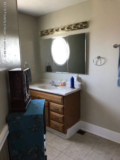 520 Elm Court Rifle, CO 81650 - Photo 21 of 37 a bathroom with a sink vanity and a mirror