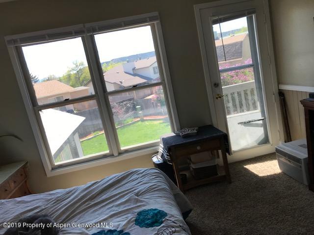 520 Elm Court Rifle, CO 81650 - Photo 23 of 37 a living room with a bed furniture and a large window