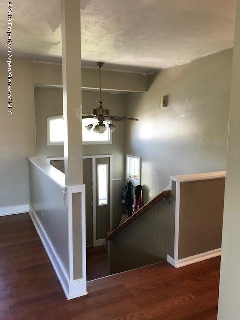 520 Elm Court Rifle, CO 81650 - Photo 31 of 37 a view of a hallway with wooden floor and staircase