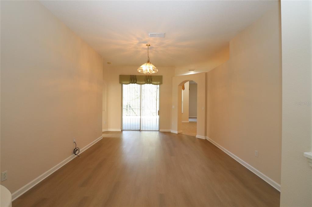 605 Cheviot Court Apopka, FL 32712 - Photo 15 of 32 an empty room with wooden floor and windows