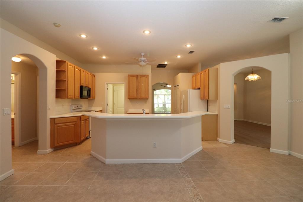 605 Cheviot Court Apopka, FL 32712 - Photo 2 of 32 a large kitchen with stainless steel appliances a large counter top