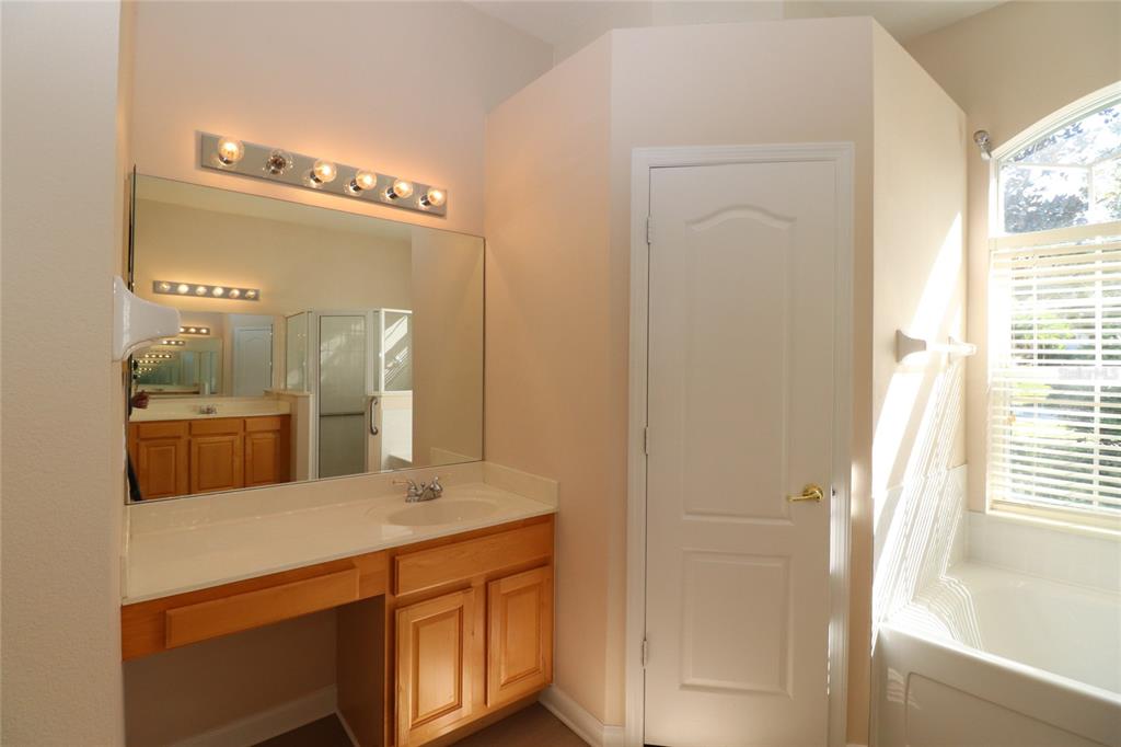 605 Cheviot Court Apopka, FL 32712 - Photo 21 of 32 a bathroom with a sink a mirror and a shower