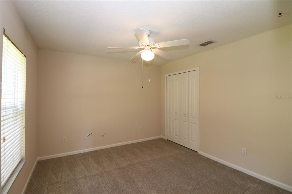 605 Cheviot Court Apopka, FL 32712 - Photo 29 of 32 an empty room with a window and a fan