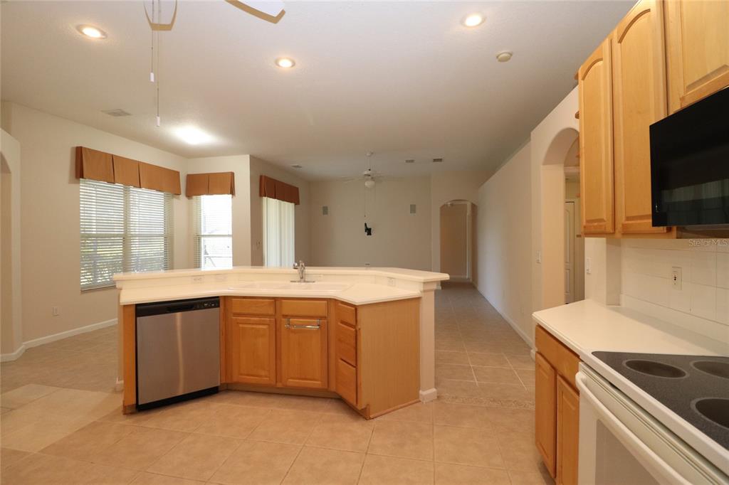 605 Cheviot Court Apopka, FL 32712 - Photo 6 of 32 a large kitchen with a large counter top and stainless steel appliances