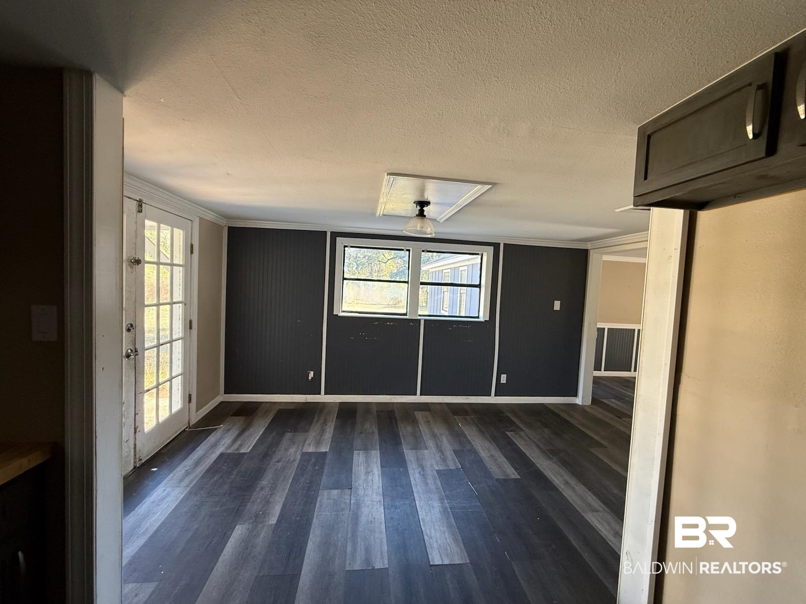 6745 Carol Plantation Road Theodore, AL 36582 - Photo 6 of 13 Unfurnished dining area with dark wood-style flooring and a textured ceiling
