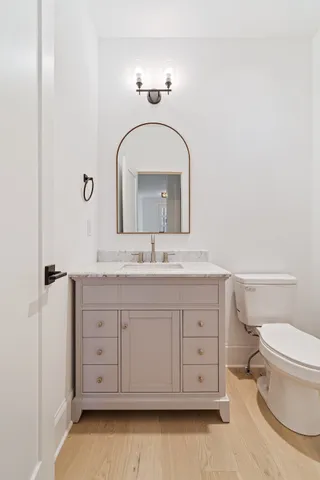 a bathroom with a toilet sink and mirror