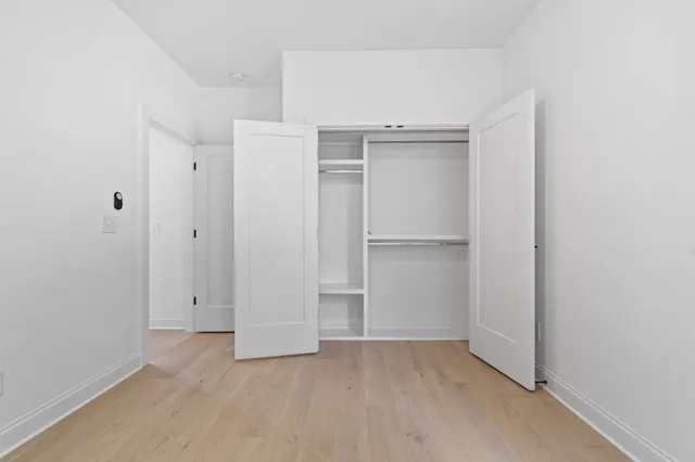 an empty room with closet area