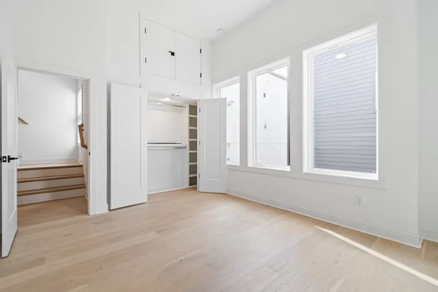 a view of an empty room with a kitchen