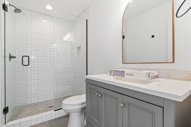 a bathroom with a sink toilet and shower