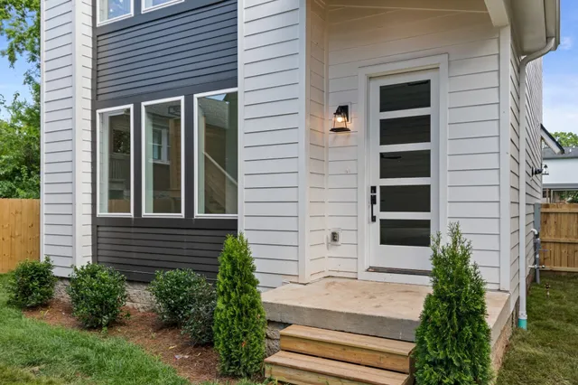 a view of a brick house with plants