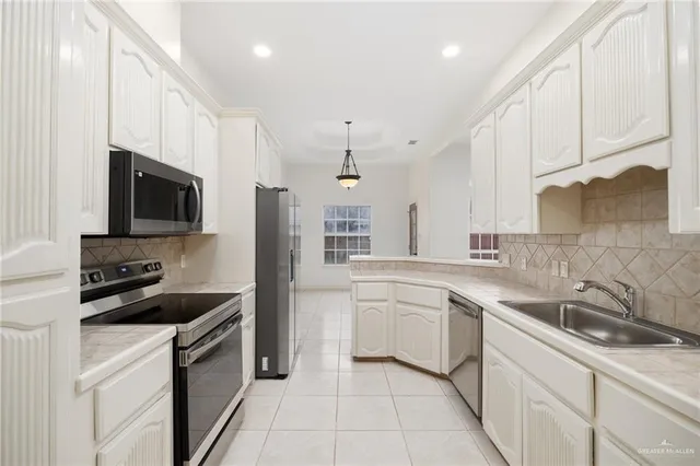 a kitchen with a sink stove top oven and cabinets