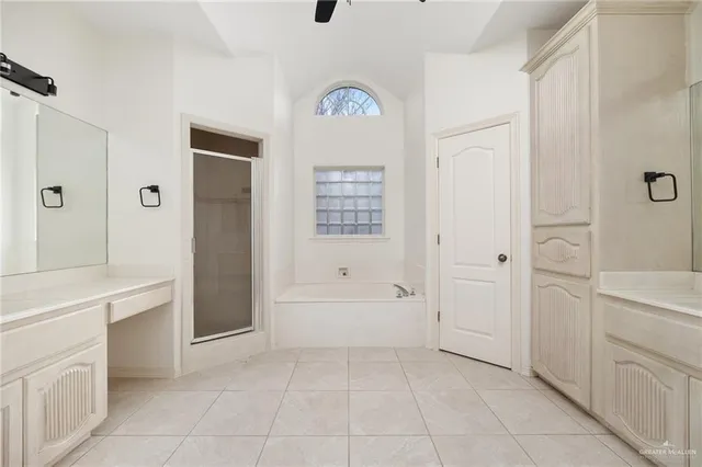 a bathroom with a bathtub a sink a vanity and a shower