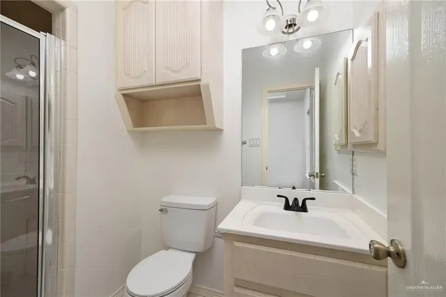 a bathroom with a sink a toilet and mirror