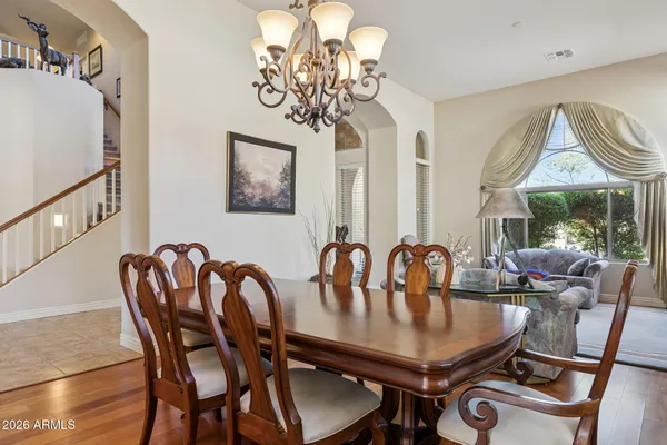 a view of staircase with lots of frames on wall and a painting