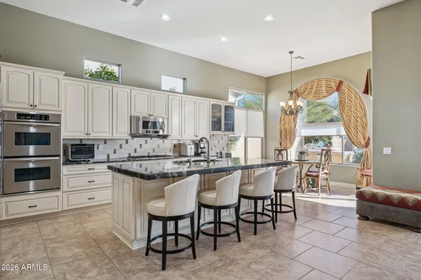 a bedroom with a bed a couch and a window