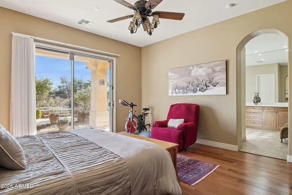 a front view of a house with a yard and mountain view in back