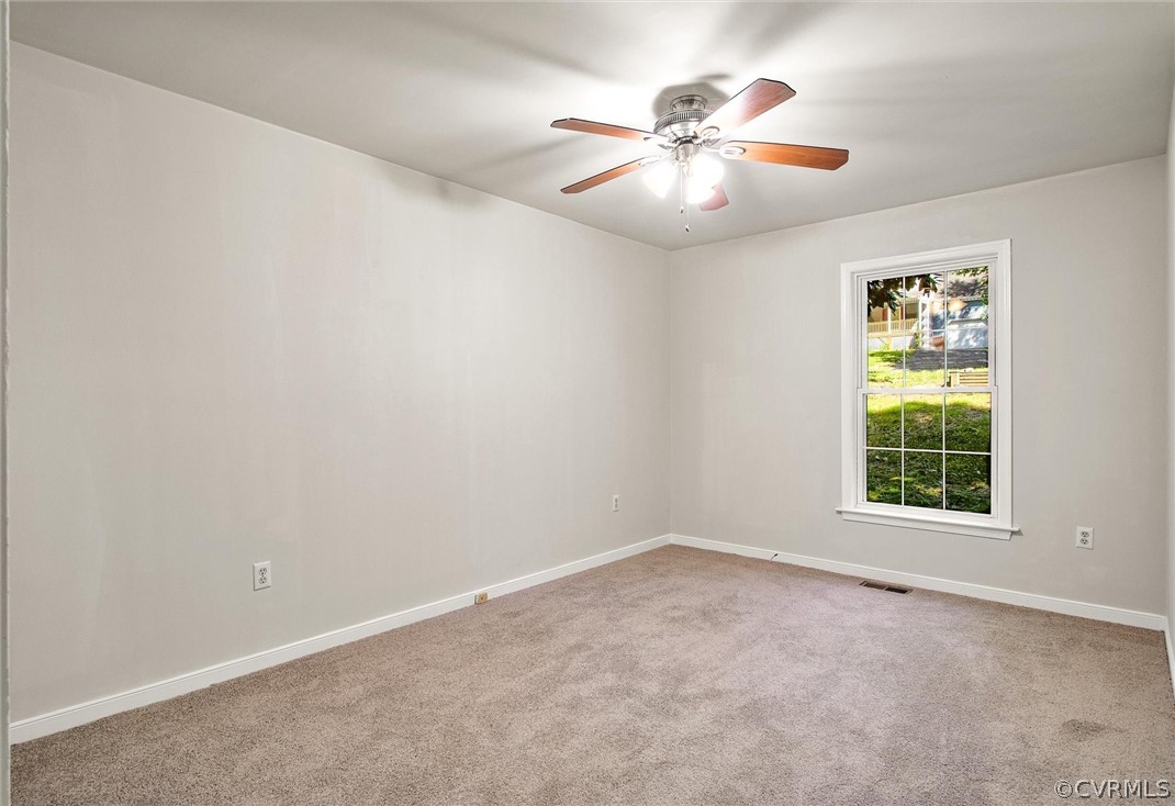 7560 Valencia Road Chesterfield, VA 23832 - Photo 11 of 26 an empty room with window and chandelier fan