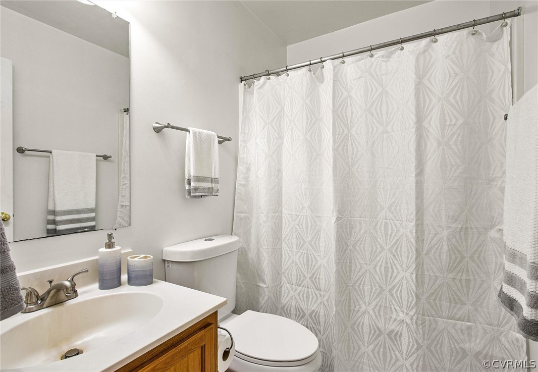 7560 Valencia Road Chesterfield, VA 23832 - Photo 12 of 26 a bathroom with a sink a toilet and a mirror