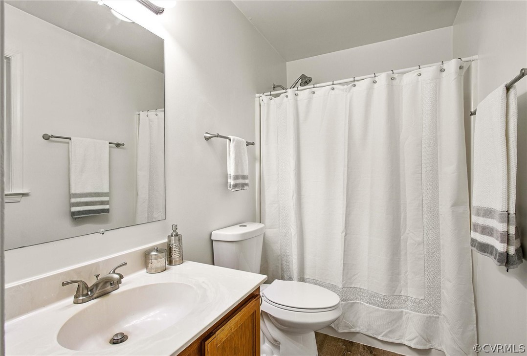 7560 Valencia Road Chesterfield, VA 23832 - Photo 13 of 26 a bathroom with a sink a toilet and shower curtain