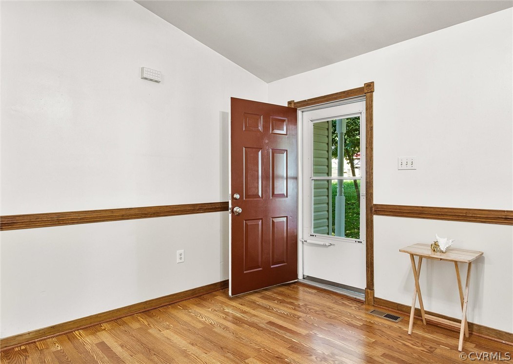 7560 Valencia Road Chesterfield, VA 23832 - Photo 16 of 26 a view of an empty room with wooden floor and a window
