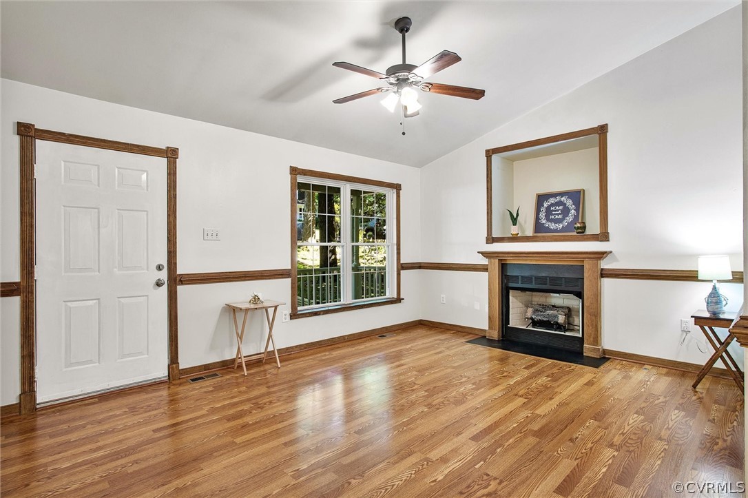 7560 Valencia Road Chesterfield, VA 23832 - Photo 2 of 26 an empty room with wooden floor fireplace and windows