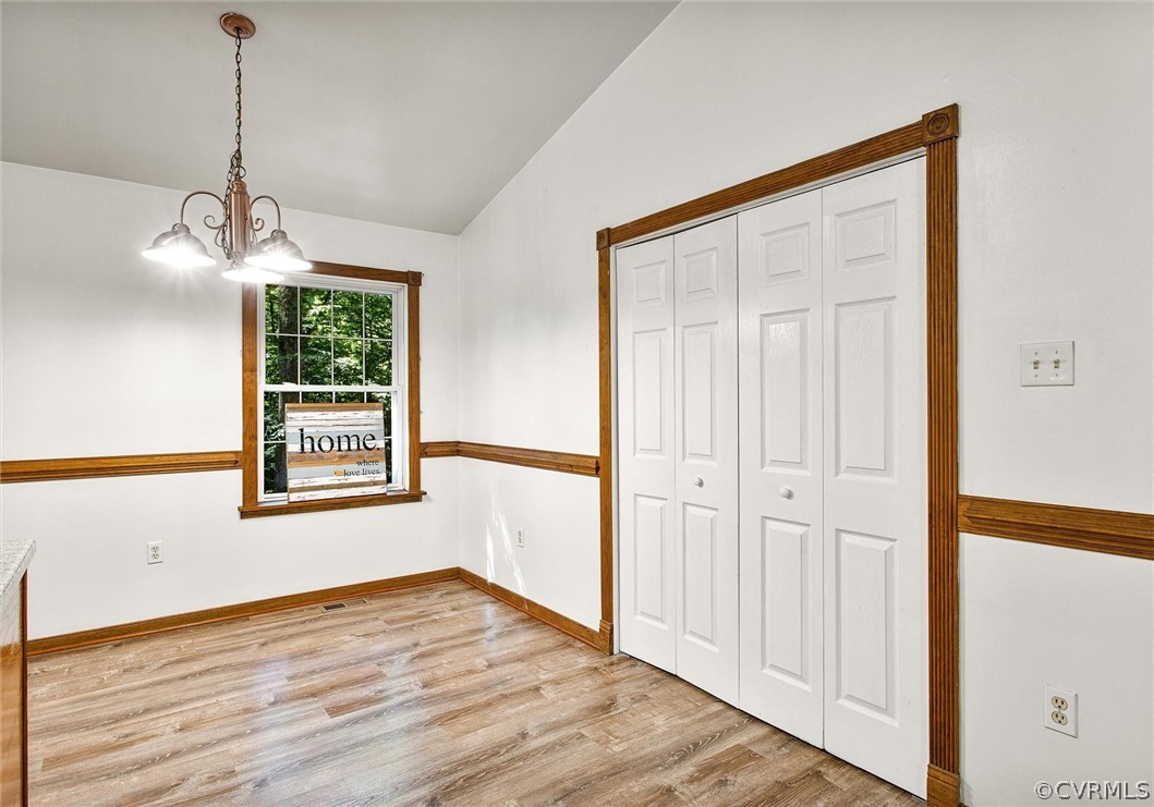 7560 Valencia Road Chesterfield, VA 23832 - Photo 6 of 26 a view of an empty room with wooden floor and a window