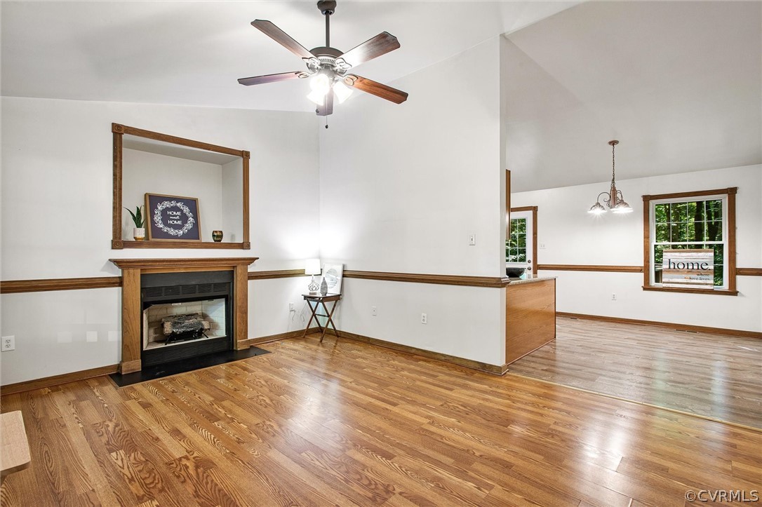 7560 Valencia Road Chesterfield, VA 23832 - Photo 7 of 26 a view of a livingroom with a fireplace a ceiling fan and wooden floor