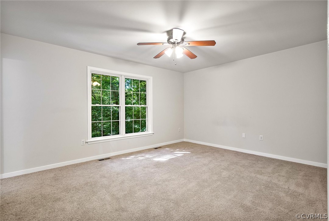 7560 Valencia Road Chesterfield, VA 23832 - Photo 9 of 26 an empty room with windows and fan