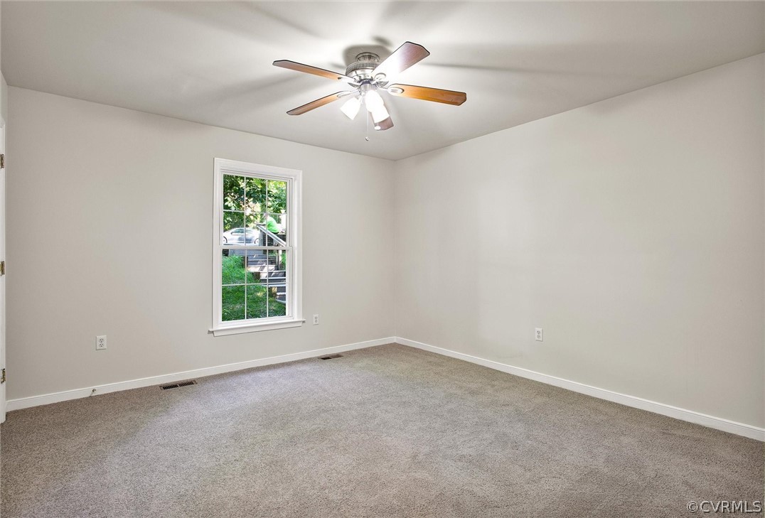 7560 Valencia Road Chesterfield, VA 23832 - Photo 10 of 26 an empty room with windows and chandelier fan