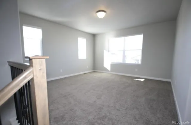 a view of empty room with window and fireplace