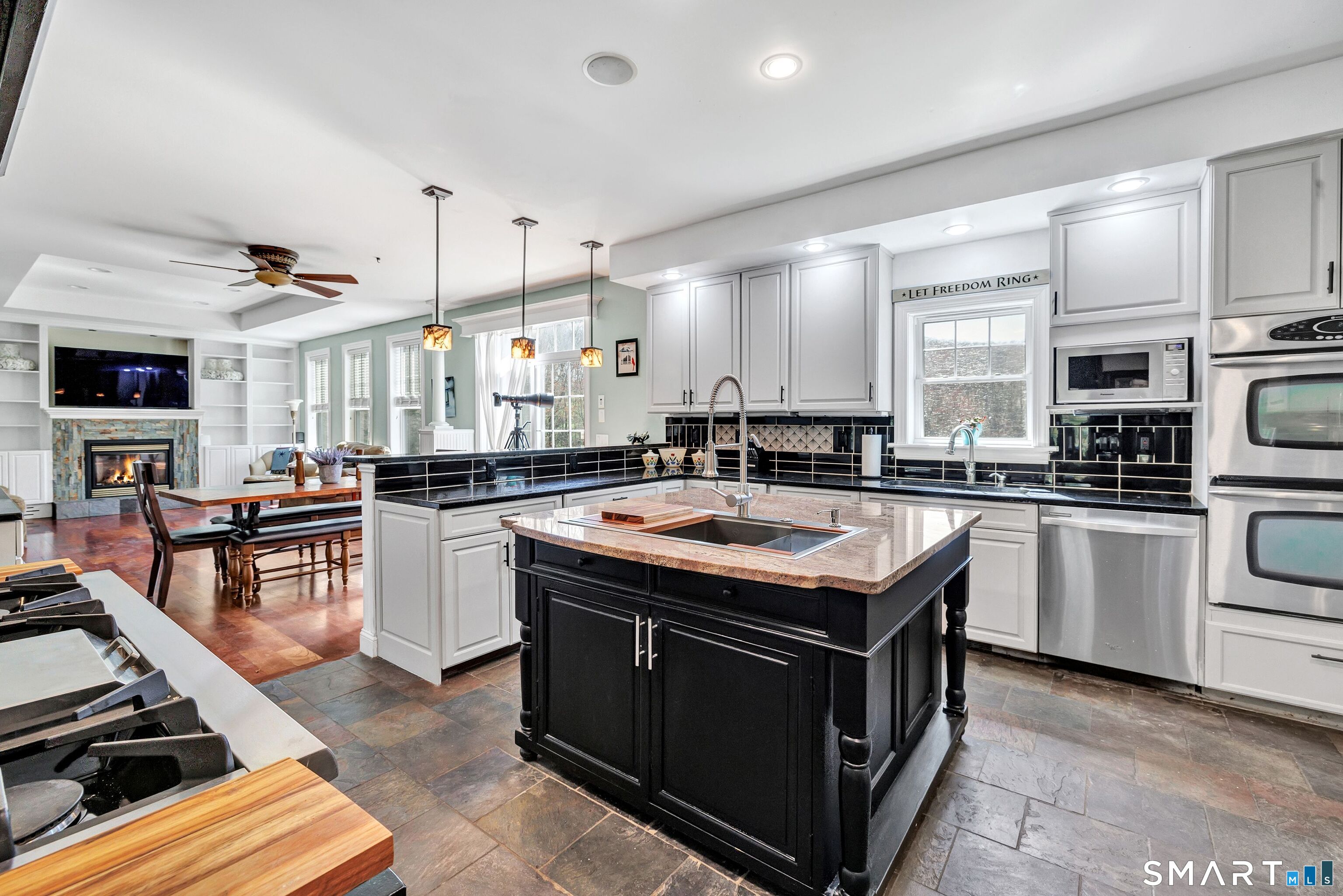 25 Starrs Ridge Road Redding, CT 06896 - Photo 38 of 38 At the heart of the home is this custom designed chef's kitchen, thoughtfully integrated into the open floor plan. The space flows seamlessly into the dining area & family room, creating an inviting setting for both every day living and entertaining.