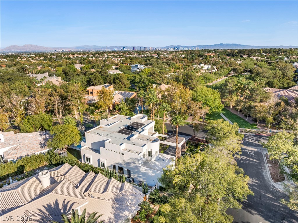2000 Grouse Street Las Vegas, NV 89134 - Photo 79 of 89 An aerial perspective reveals a modern residence nestled amongst lush greenery with city views beyond.