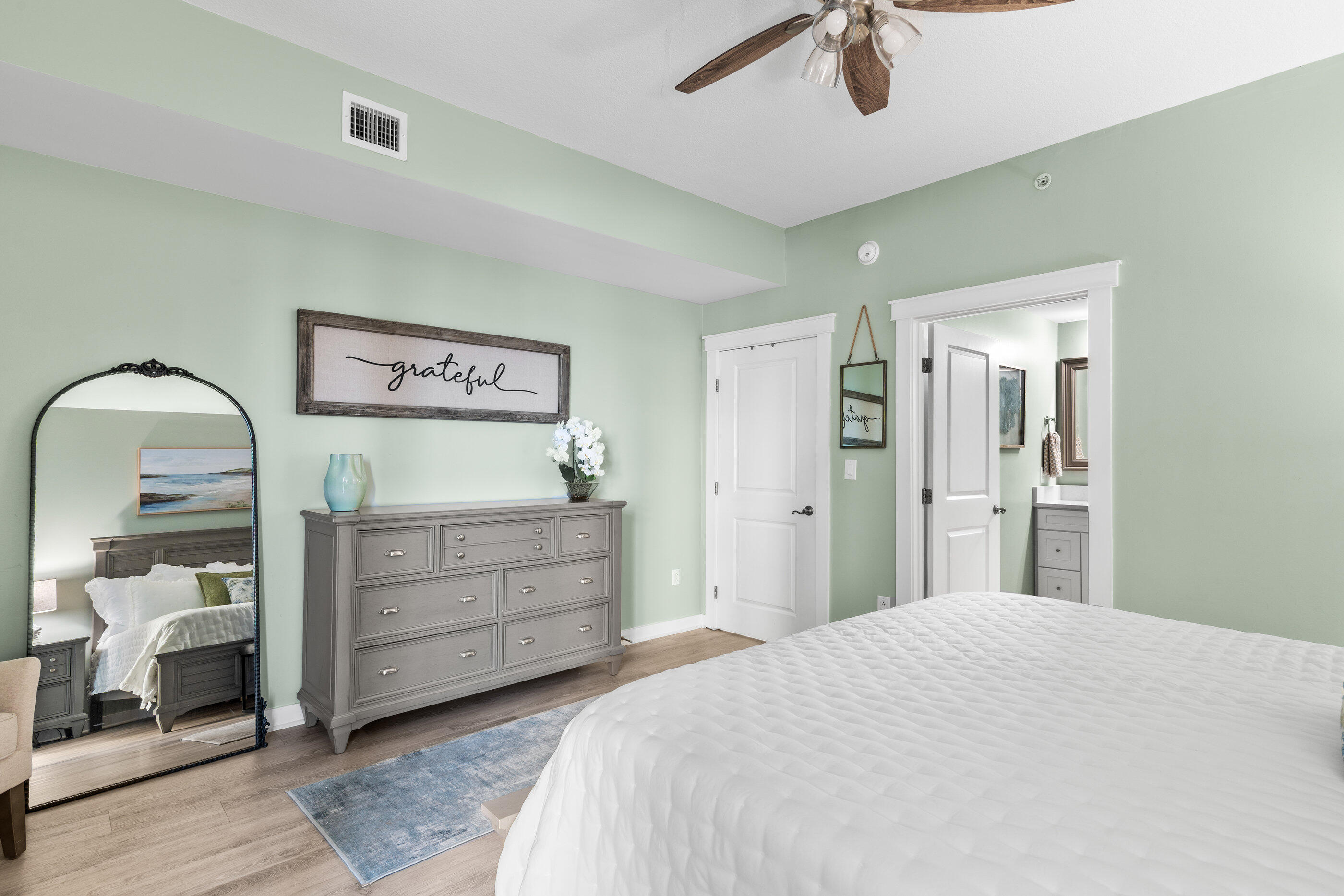 15100 Front Beach Road, Unit 424 Panama City Beach, FL 32413 - Photo 14 of 30 a bedroom with a bed and a chandelier