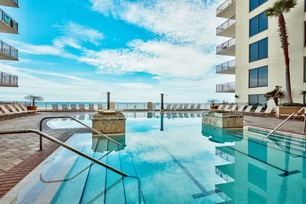 a swimming pool with outdoor seating and city view