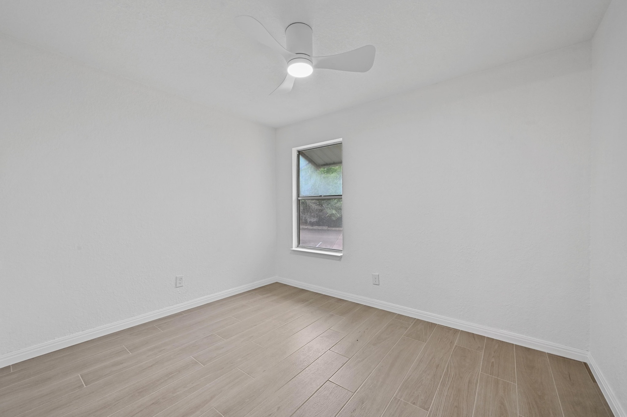 3204 Menchaca Road, Unit 212 Austin, TX 78704 - Photo 19 of 22 wooden floor in an empty room with a window