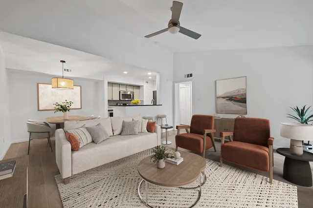 a living room with furniture and a wooden floor