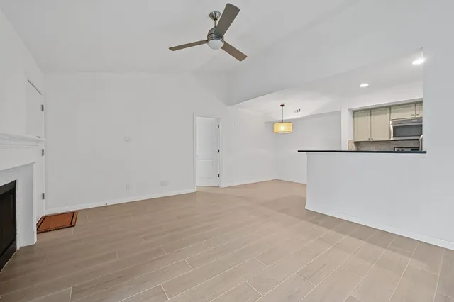 a view of a kitchen with a dishwasher and white cabinets