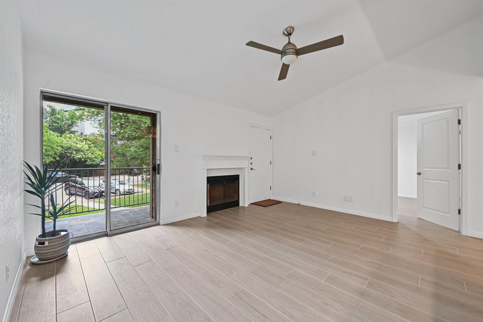 3204 Menchaca Road, Unit 212 Austin, TX 78704 - Photo 10 of 22 an empty room with floor to ceiling windows and ceiling fan